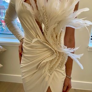 White one shoulder long sleeve gown with inside corset with feather